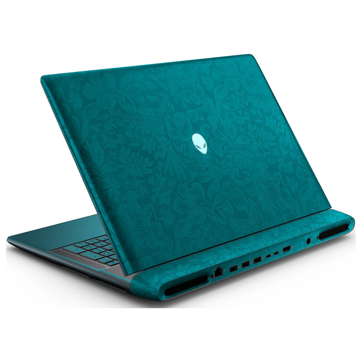 Rear left three-quarter view of an open Alienware 18 Area-51 (2025) with Tropical Teal Hibiscus skin, showing the floral lid and keyboard deck to the left.
