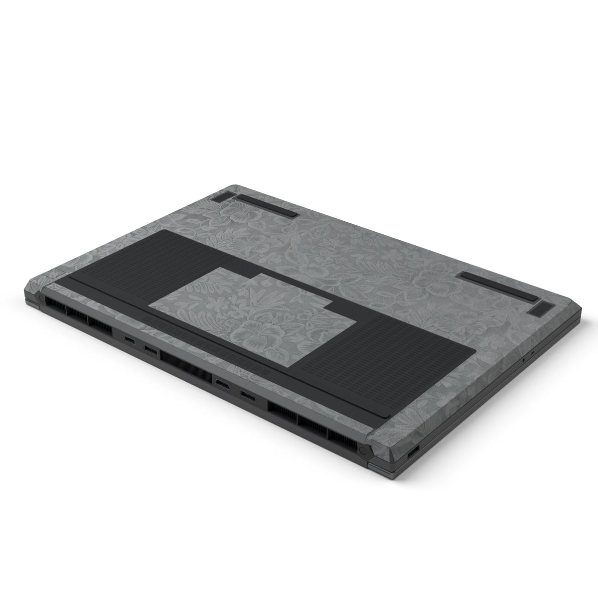 Dwantran Hibiscus Lenovo laptop skin in Classic Gray, showing an oblique view of the laptop underside on a white background.