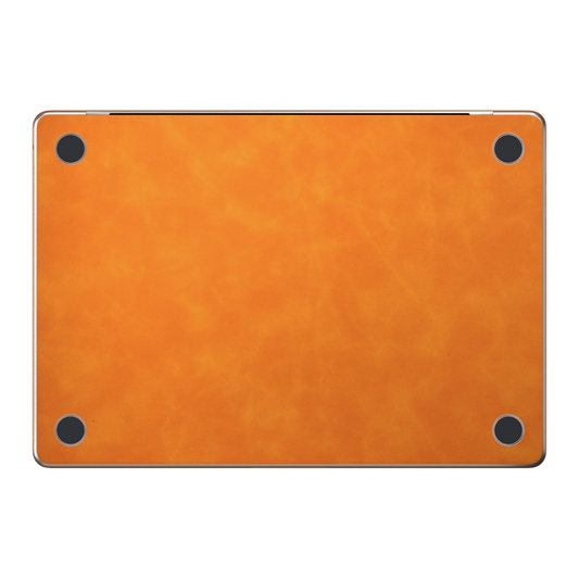 Orange scrub-textured synthetic leather MacBook skin. Bottom (D) material illustration; included only with bottom coverage. Air 15.3 M3-M5 shared material/installation illustration; actual cutouts and included pieces follow the selected model and coverage. Laptop not included.