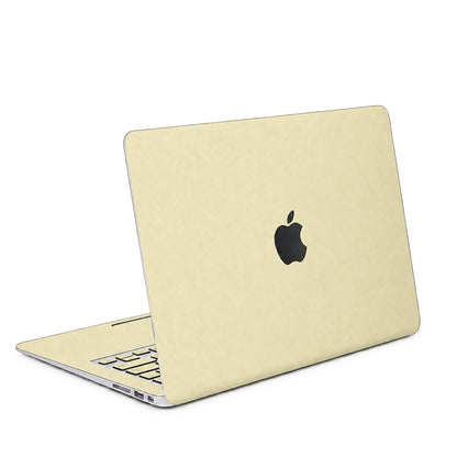 AI-assisted champagne gold MacBook skin visualisation showing the top lid and matching inside keycap stickers. Cut layout varies by model.