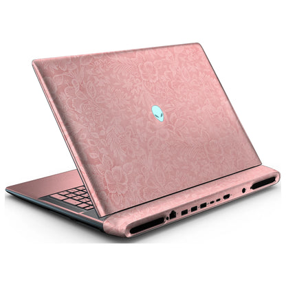 Rear left three-quarter view of an open Alienware 18 Area-51 (2025) with Blush Pink Hibiscus skin, showing the floral lid and keyboard deck to the left.