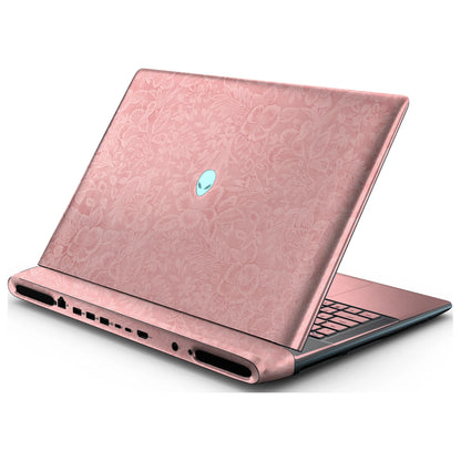 Rear right three-quarter view of an open Alienware 18 Area-51 (2025) with Blush Pink Hibiscus skin, showing the floral lid and keyboard deck to the right.