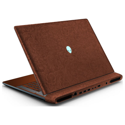 Rear left three-quarter view of an open Alienware 18 Area-51 (2025) with Classic Brown Hibiscus skin, showing the floral lid and keyboard deck to the left.
