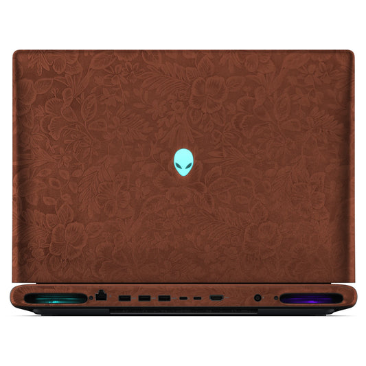 Rear view of an open Alienware 18 Area-51 (2025) with Classic Brown Hibiscus skin, showing the floral outer lid, rear ports and vents.