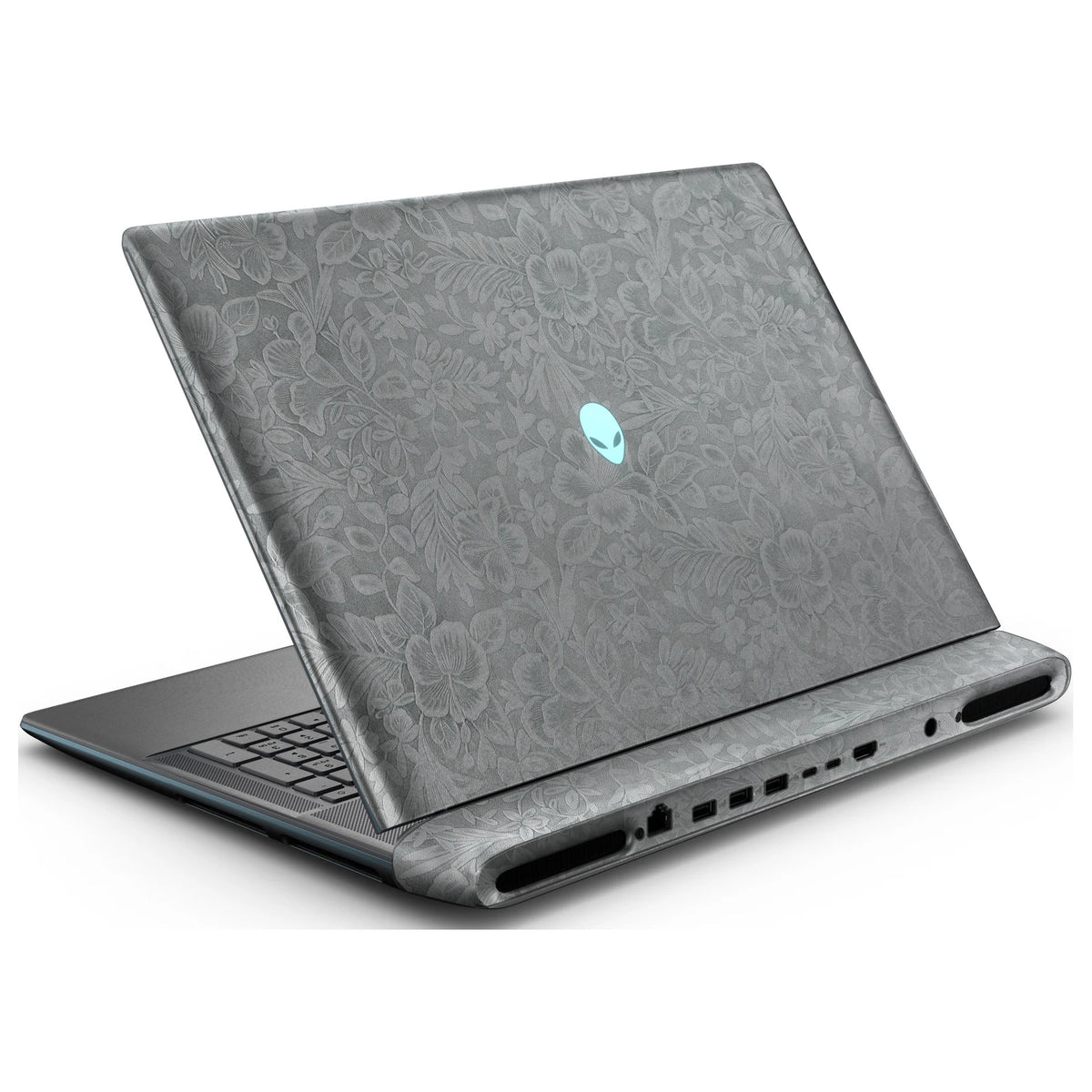 Rear left three-quarter view of an open Alienware 18 Area-51 (2025) with Classic Gray Hibiscus skin, showing the floral lid and keyboard deck to the left.