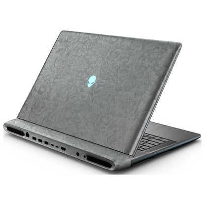 Rear right three-quarter view of an open Alienware 18 Area-51 (2025) with Classic Gray Hibiscus skin, showing the floral lid and keyboard deck to the right.