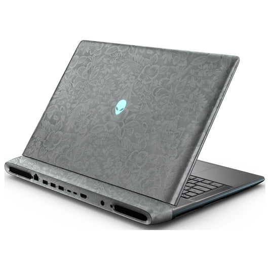 Rear right three-quarter view of an open Alienware 18 Area-51 (2025) with Classic Gray Hibiscus skin, showing the floral lid and keyboard deck to the right.