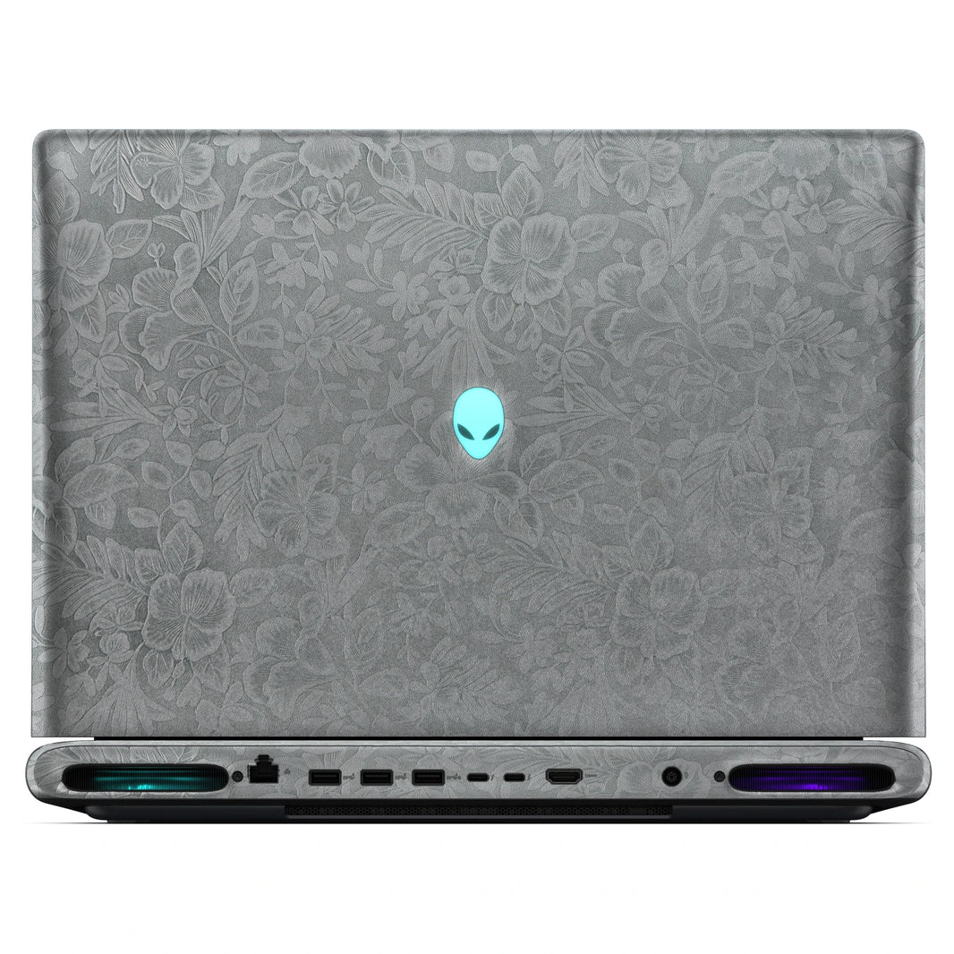 Rear view of an open Alienware 18 Area-51 (2025) with Classic Gray Hibiscus skin, showing the floral outer lid, rear ports and vents.