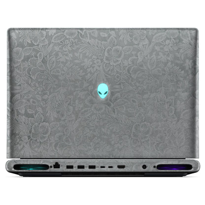 Rear view of an open Alienware 18 Area-51 (2025) with Classic Gray Hibiscus skin, showing the floral outer lid, rear ports and vents.