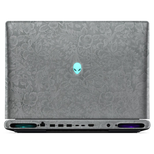 Rear view of an open Alienware 18 Area-51 (2025) with Classic Gray Hibiscus skin, showing the floral outer lid, rear ports and vents.