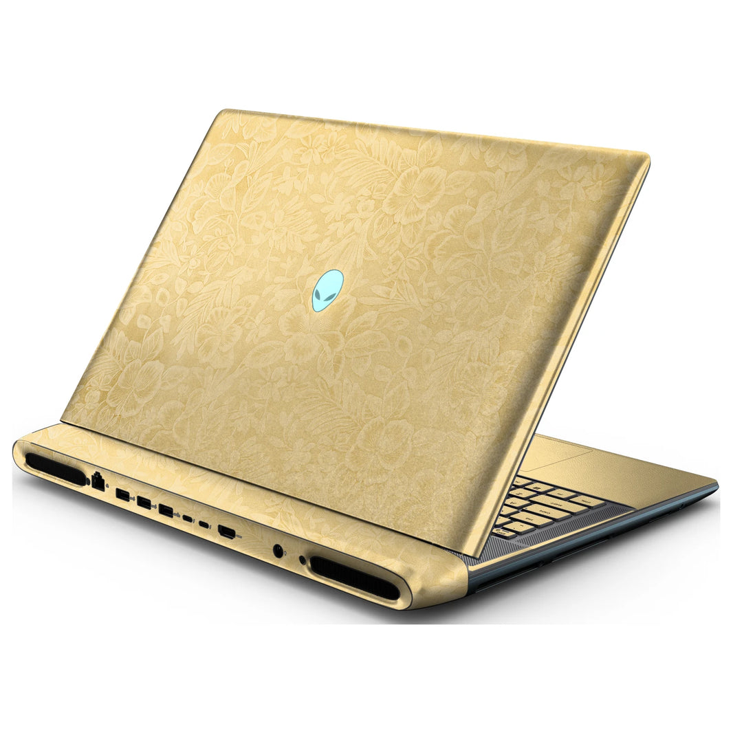 Rear right three-quarter view of an open Alienware 18 Area-51 (2025) with Vintage Gold Hibiscus skin, showing the floral lid and keyboard deck to the right.
