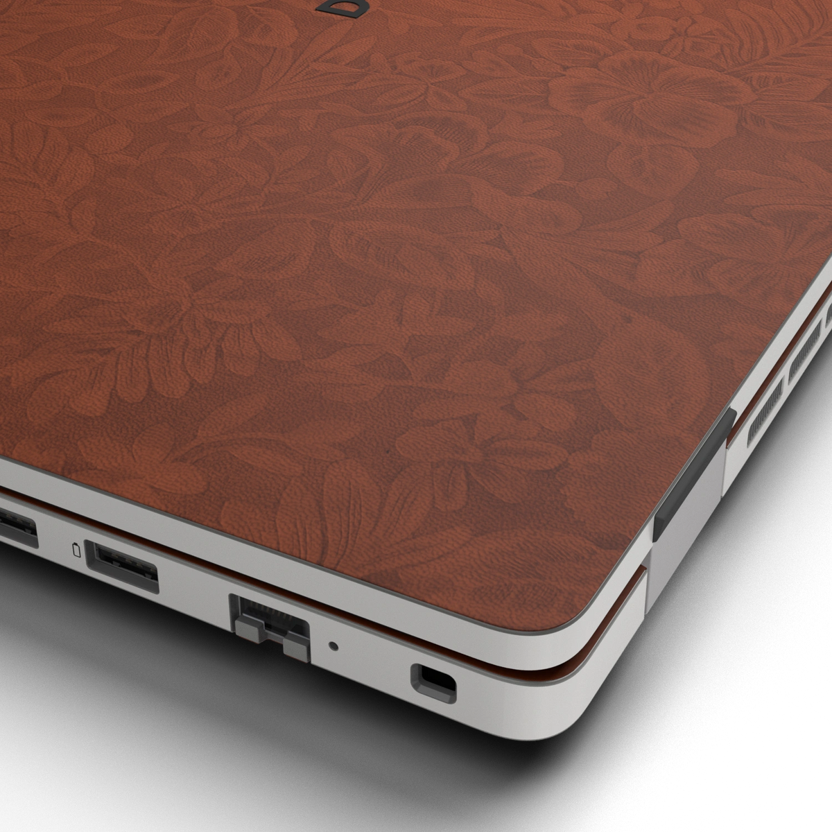 Hibiscus-embossed top lid material close-up of Classic Brown Hibiscus synthetic leather skin, rendered on Dell Pro 16 (PC16250) as a model reference.