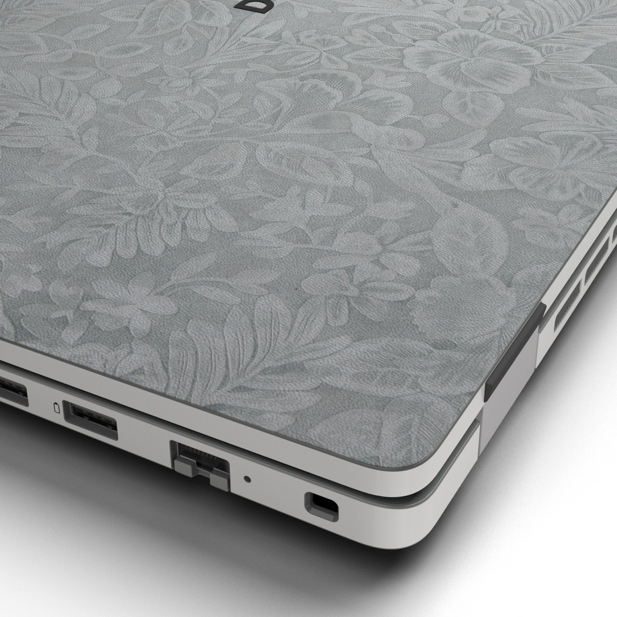 Hibiscus-embossed top lid material close-up of Classic Gray Hibiscus synthetic leather skin, rendered on Dell Pro 16 (PC16250) as a model reference.