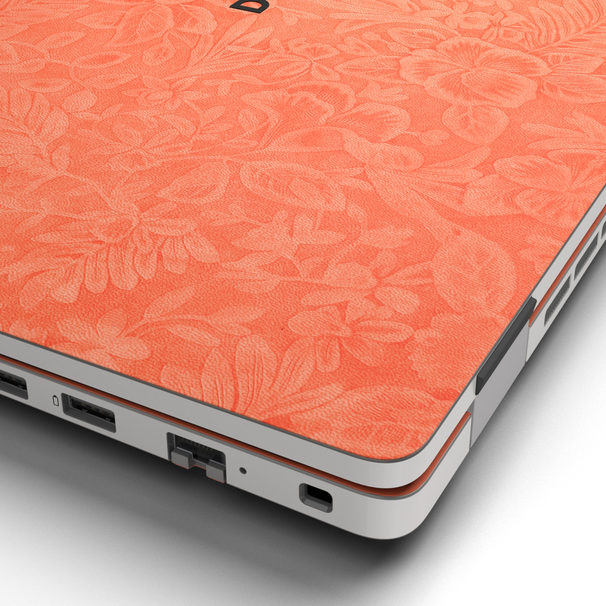 Hibiscus-embossed top lid material close-up of Sunset Orange Hibiscus synthetic leather skin, rendered on Dell Pro 16 (PC16250) as a model reference.