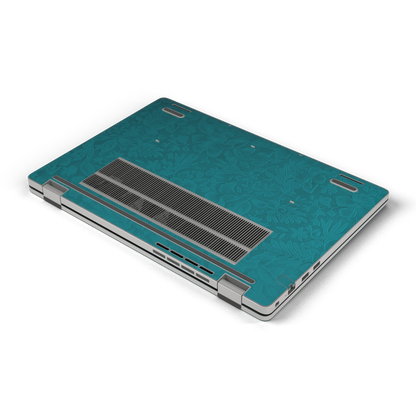 Oblique bottom view of Tropical Teal Hibiscus synthetic leather skin, rendered on Dell Pro 16 (PC16250) as a model reference.