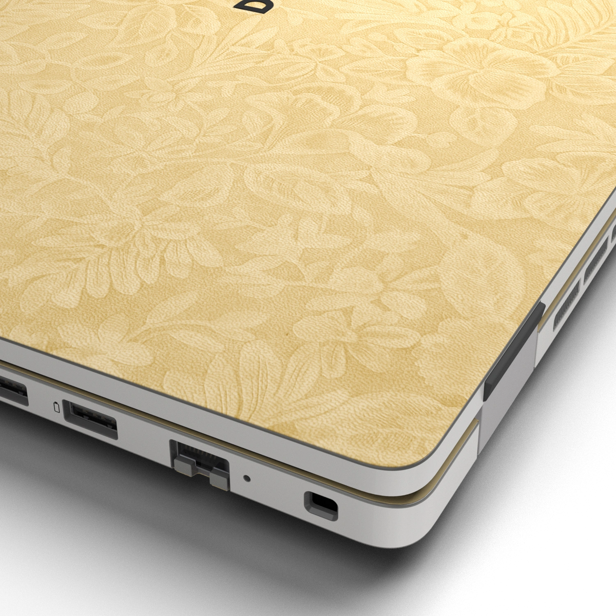 Hibiscus-embossed top lid material close-up of Vintage Gold Hibiscus synthetic leather skin, rendered on Dell Pro 16 (PC16250) as a model reference.
