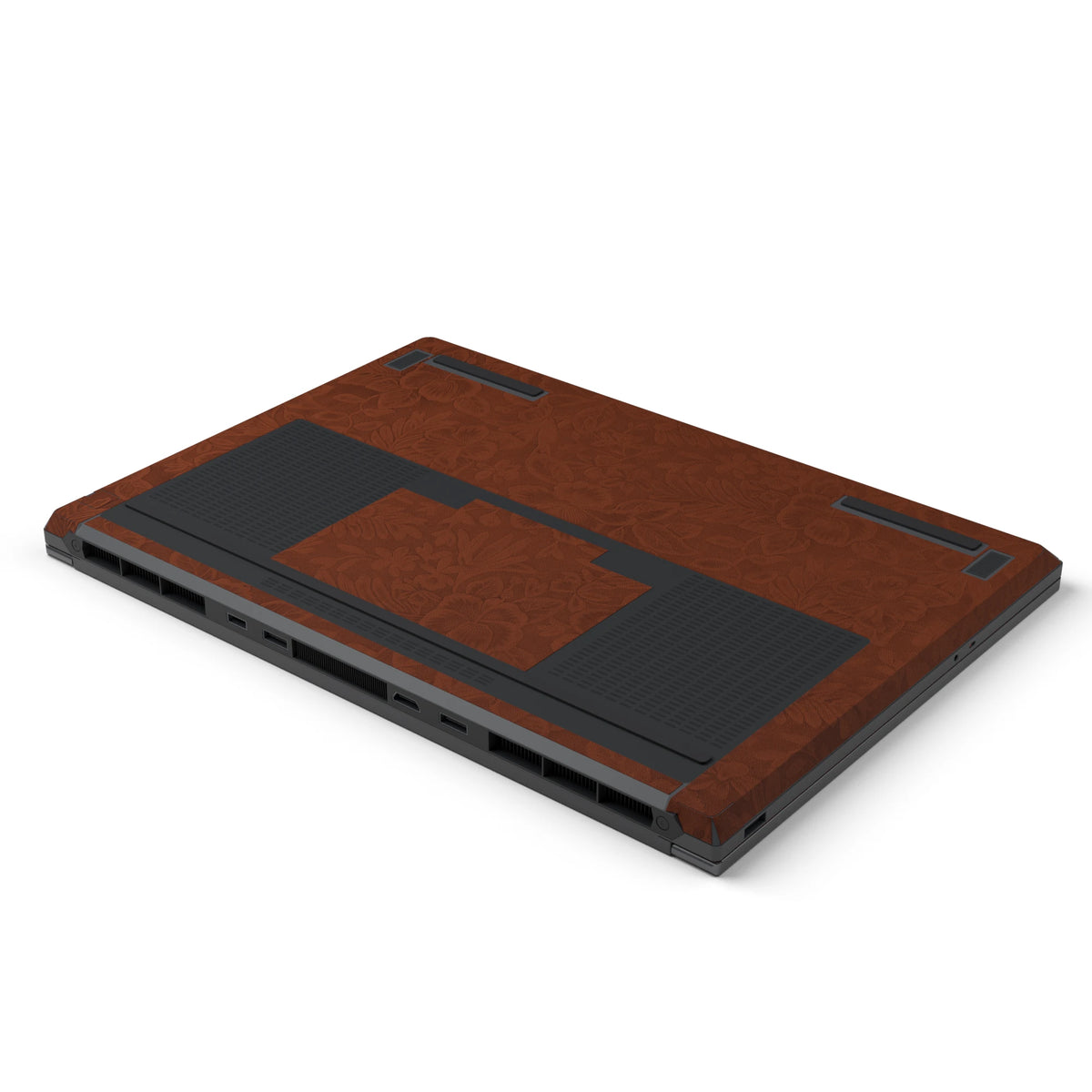 Dwantran Hibiscus Lenovo laptop skin in Classic Brown, showing an oblique view of the laptop underside on a white background.