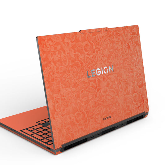 Dwantran Hibiscus Lenovo laptop skin in Sunset Orange, showing an oblique view of the laptop lid on a white background.