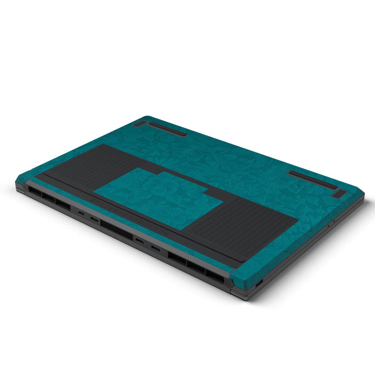 Dwantran Hibiscus Lenovo laptop skin in Tropical Teal, showing an oblique view of the laptop underside on a white background.