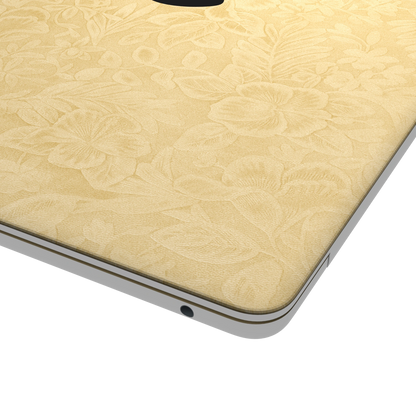 Vintage Gold Hibiscus Embossed Synthetic Leather MacBook Skin: top-lid (A) corner material detail. Rendered on MacBook Air as a shared material and colour reference; not an image of every supported model. Exact fit and included pieces follow the selected options. Laptop not included.