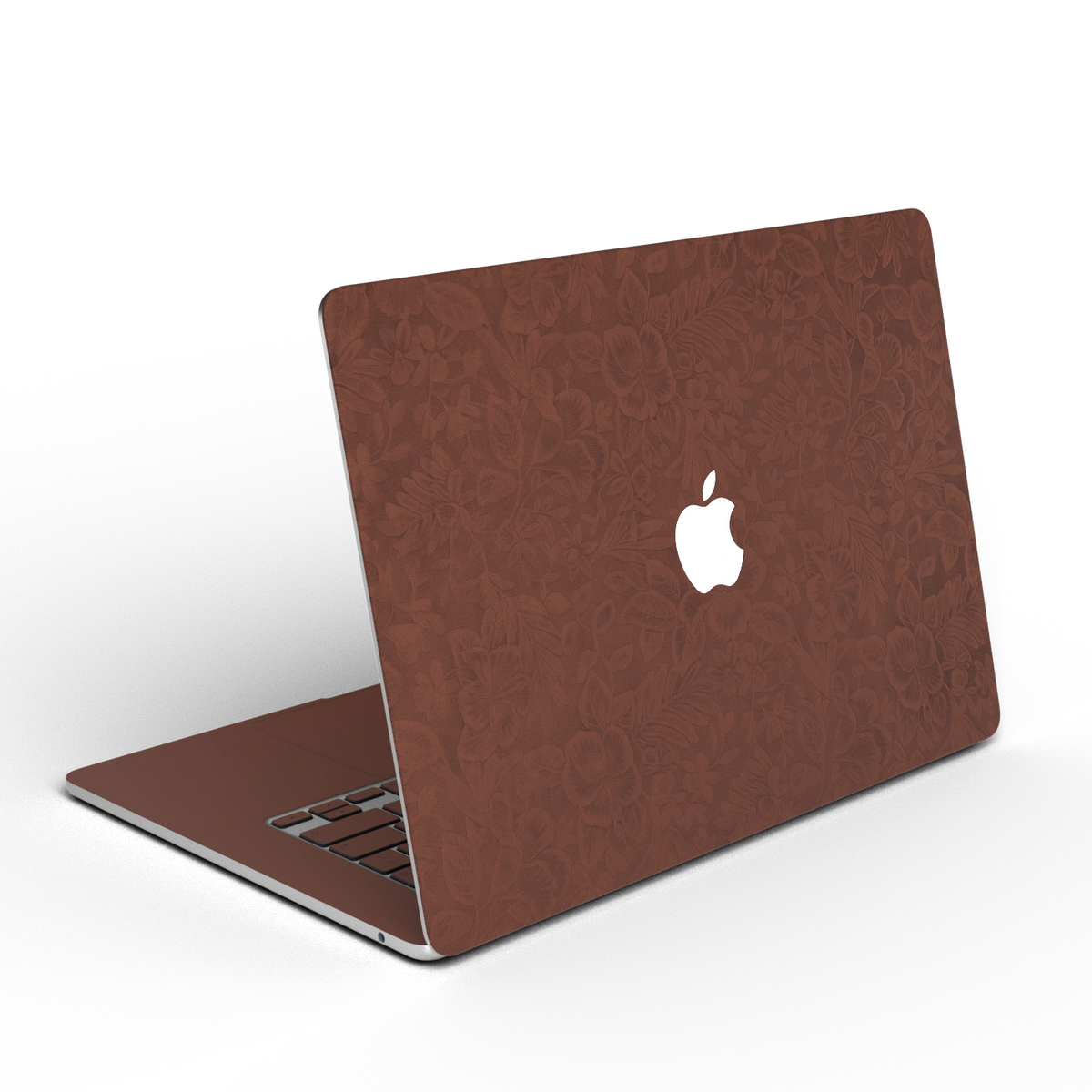 Classic Brown Hibiscus synthetic leather: Rear installation-effect illustration of embossed exterior material. Rendered on Air 15.3-inch M3-M5 as shared Air/Pro/Neo material reference; exact cutouts follow selected model.