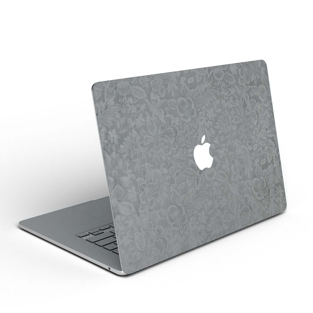 Classic Gray Hibiscus synthetic leather: Rear installation-effect illustration of embossed exterior material. Rendered on Air 15.3-inch M3-M5 as shared Air/Pro/Neo material reference; exact cutouts follow selected model.