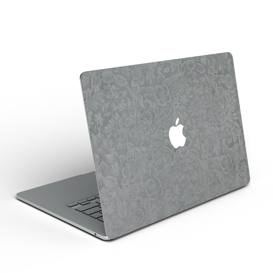 Classic Gray Hibiscus synthetic leather: Rear installation-effect illustration of embossed exterior material. Rendered on Air 15.3-inch M3-M5 as shared Air/Pro/Neo material reference; exact cutouts follow selected model.