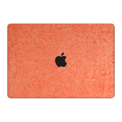 Sunset Orange Hibiscus embossed synthetic leather material illustration on the top lid (A). Rendered on MacBook Air 15.3-inch M3-M5 as a shared material reference for Air, Pro and Neo; actual cutouts follow the selected model.