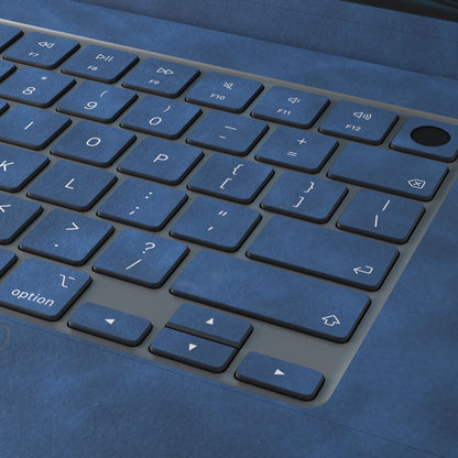 Dark Gray Blue scrub-textured synthetic leather MacBook skin. Close-up of the actual scrub-textured material finish. Air 15.3 M3-M5 shared material/installation reference; exact cutouts and included pieces follow selected model and coverage. Laptop not included.