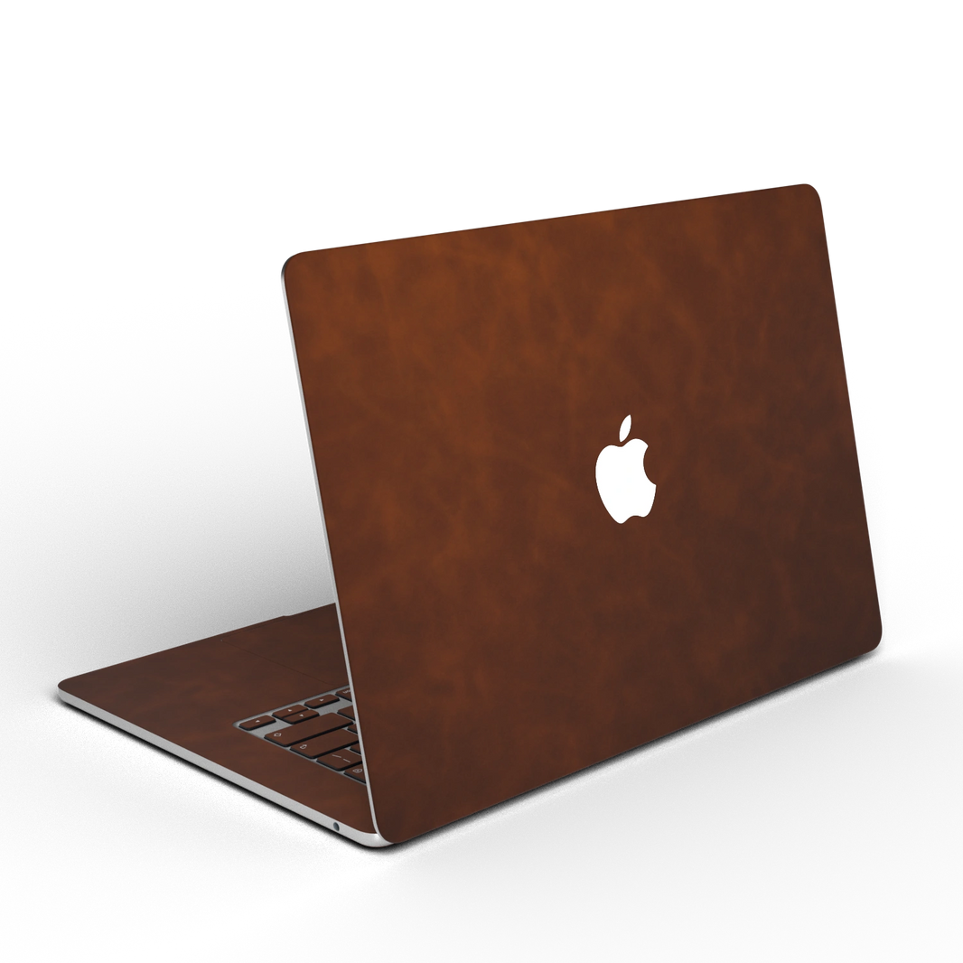 Coffee Brown scrub-textured synthetic leather MacBook skin, open rear angle material illustration. Rendered on MacBook Air 15.3 M3-M5 as shared material reference; exact cutouts and included pieces follow the selected model and coverage. Laptop not included.