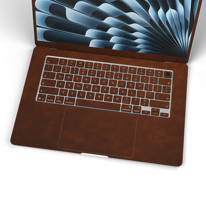 Coffee Brown scrub-textured synthetic leather MacBook skin. Wide keyboard and inside material detail. Air 15.3 M3-M5 shared material/installation reference; exact cutouts and included pieces follow the selected model and coverage. Laptop not included.
