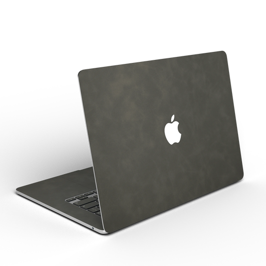 Dark Gray scrub-textured synthetic leather MacBook skin. Open rear angle material illustration. Air 15.3 M3-M5 shared material/installation reference; exact cutouts and included pieces follow selected model and coverage. Laptop not included.