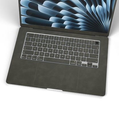 Dark Gray scrub-textured synthetic leather MacBook skin. Wide keyboard and inside material detail. Air 15.3 M3-M5 shared material/installation reference; exact cutouts and included pieces follow selected model and coverage. Laptop not included.