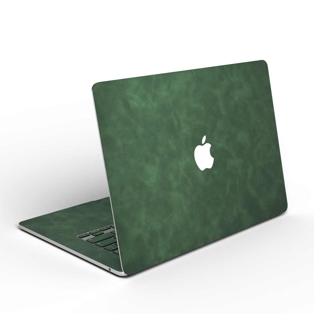 Green scrub-textured synthetic leather MacBook skin. Open rear angle material illustration. Air 15.3 M3-M5 shared material/installation reference; exact cutouts and included pieces follow selected model and coverage. Laptop not included.