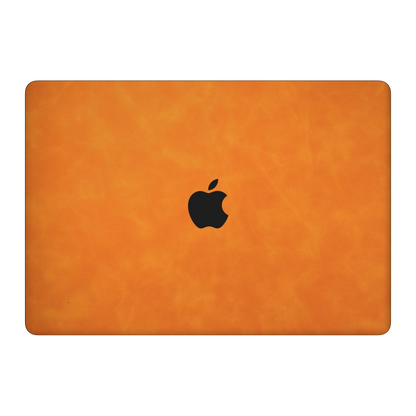 Orange scrub-textured synthetic leather MacBook skin. Top lid (A) material illustration. Air 15.3 M3-M5 shared material/installation illustration; actual cutouts and included pieces follow the selected model and coverage. Laptop not included.