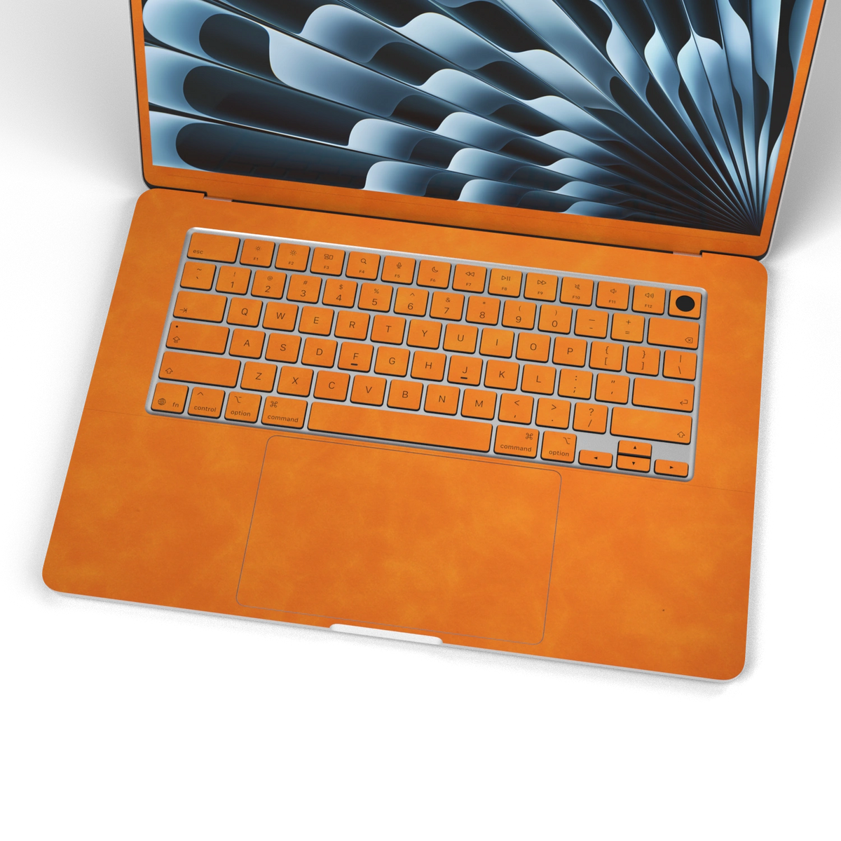 Orange scrub-textured synthetic leather MacBook skin. Wide keyboard and inside material detail. Air 15.3 M3-M5 shared material/installation illustration; actual cutouts and included pieces follow the selected model and coverage. Laptop not included.