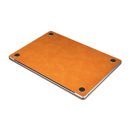 Orange scrub-textured synthetic leather MacBook skin. Bottom material and installation detail. Air 15.3 M3-M5 shared material/installation illustration; actual cutouts and included pieces follow the selected model and coverage. Laptop not included.