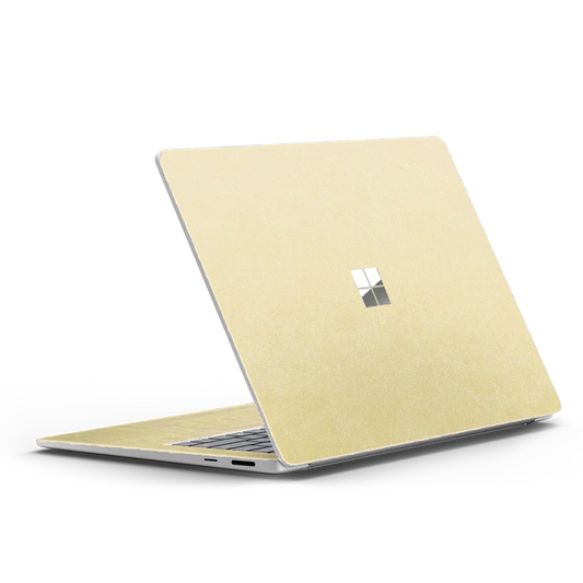 Microsoft Surface Laptop 13.8 inch with plain gold leather top lid, partially open